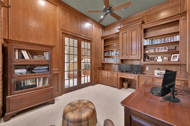 home office with carpet, visible vents, built in study area, ceiling fan, and french doors