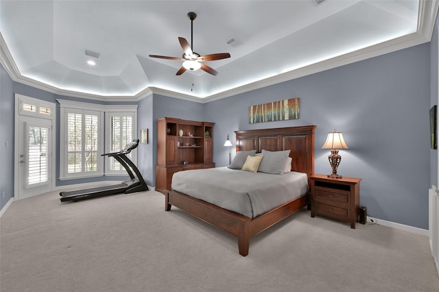 bedroom featuring a tray ceiling, baseboards, carpet, and visible vents