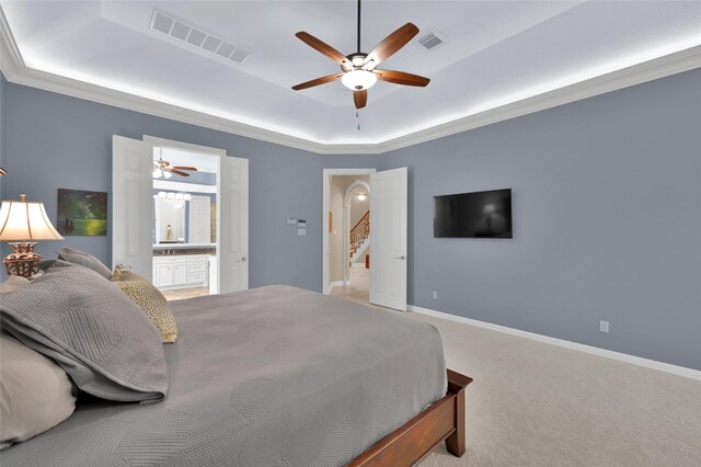 bedroom with visible vents, carpet flooring, a raised ceiling, and baseboards