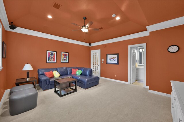 living room featuring visible vents, light carpet, a raised ceiling, ornamental molding, and baseboards