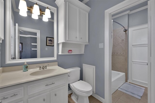 bathroom with vanity, baseboards, bathing tub / shower combination, tile patterned floors, and toilet