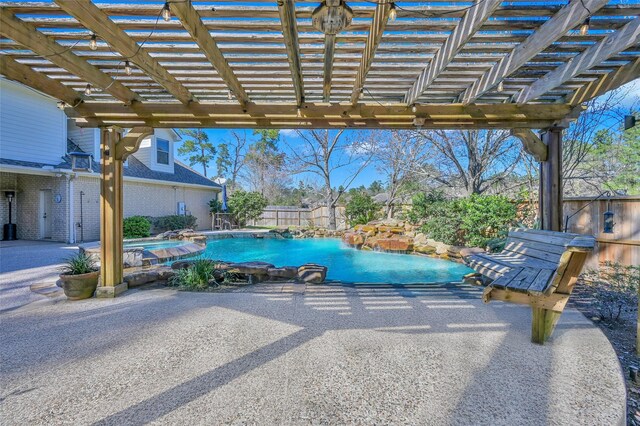 view of patio with a pool with connected hot tub, a pergola, and fence