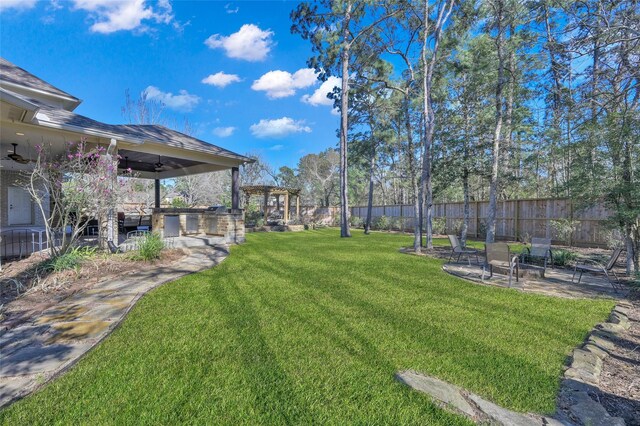 view of yard with a patio, a pergola, a ceiling fan, and fence