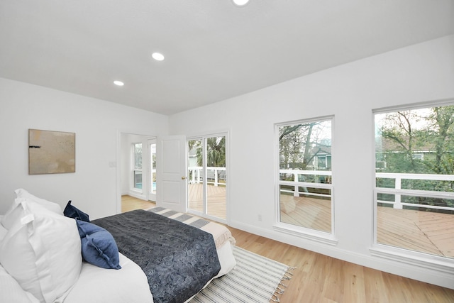 bedroom featuring access to exterior, recessed lighting, light wood-type flooring, and baseboards