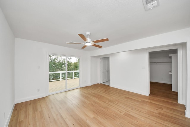 interior space with light wood-style flooring, baseboards, visible vents, and ceiling fan