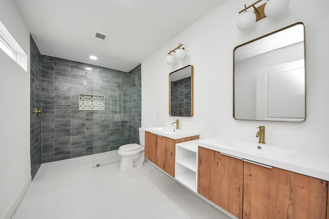 full bathroom with visible vents, toilet, two vanities, a walk in shower, and a sink