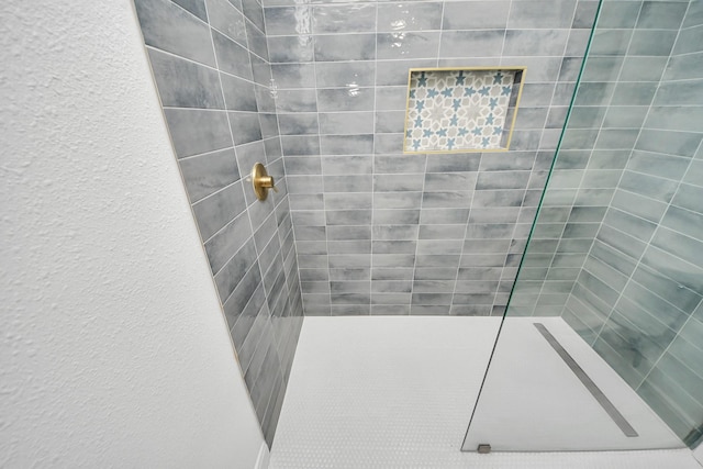 full bathroom with a tile shower