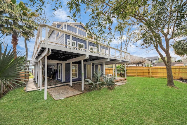 rear view of house featuring a yard, a patio area, a deck, and fence