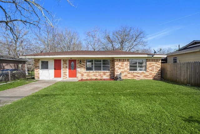 single story home featuring brick siding, a front yard, and fence