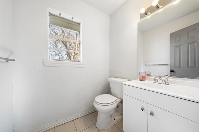 bathroom featuring tile patterned flooring, toilet, and vanity