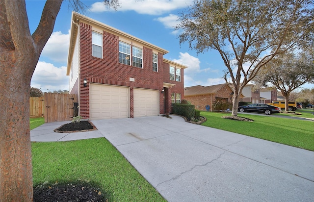 traditional home with concrete driveway, fence, brick siding, and a front yard