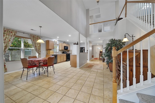 foyer entrance featuring light tile patterned flooring, stairs, and baseboards