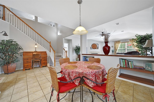 dining area featuring tile patterned flooring, stairway, and visible vents