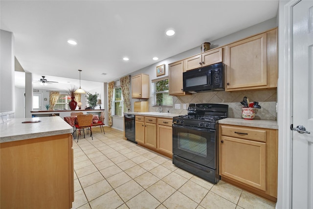 kitchen featuring tasteful backsplash, black appliances, light brown cabinetry, and light countertops