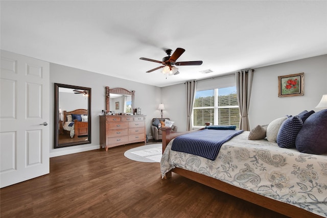 bedroom with ceiling fan, visible vents, baseboards, and wood finished floors