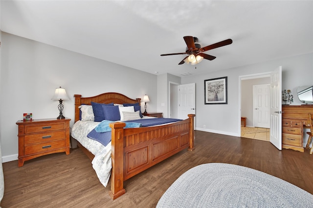 bedroom with ceiling fan, baseboards, and wood finished floors