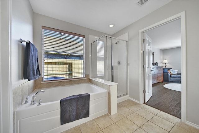 full bathroom with a stall shower, visible vents, a bath, and tile patterned flooring