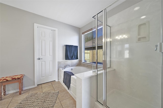 bathroom featuring a bath, a shower stall, and tile patterned flooring