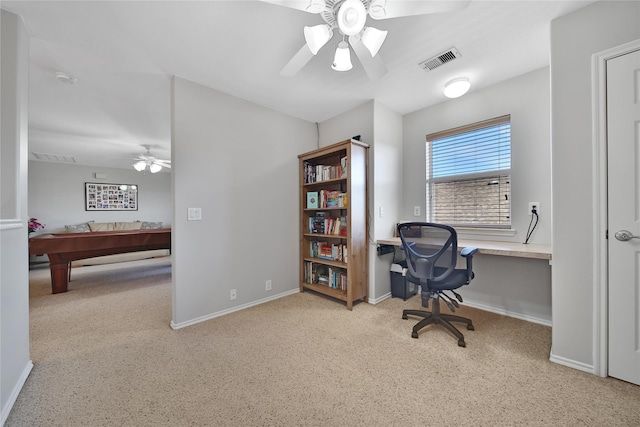 office area with carpet flooring, a ceiling fan, visible vents, and baseboards