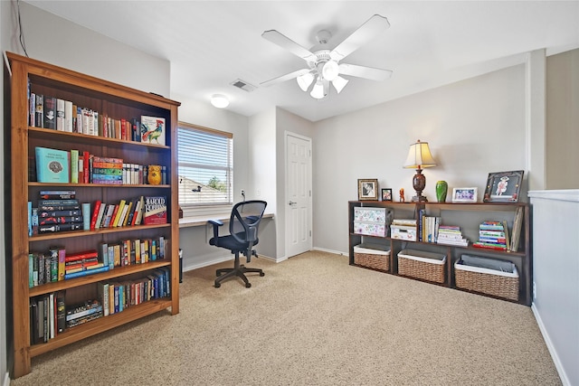 office area featuring carpet flooring, visible vents, baseboards, and ceiling fan