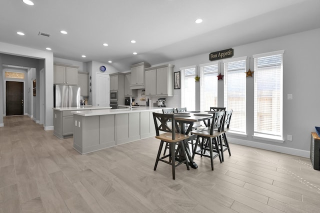 dining space with visible vents, recessed lighting, light wood-style flooring, and baseboards