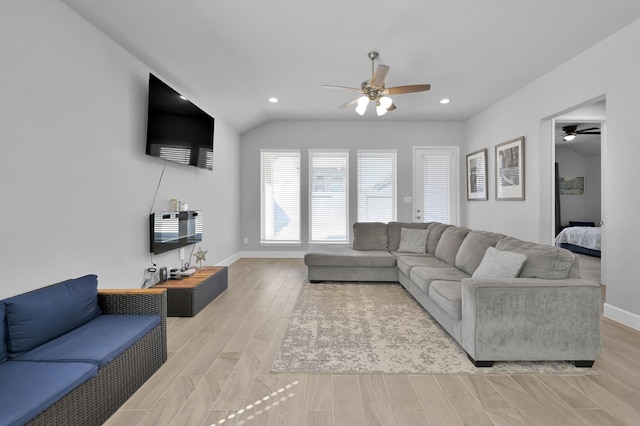 living area with baseboards, recessed lighting, ceiling fan, vaulted ceiling, and light wood-type flooring