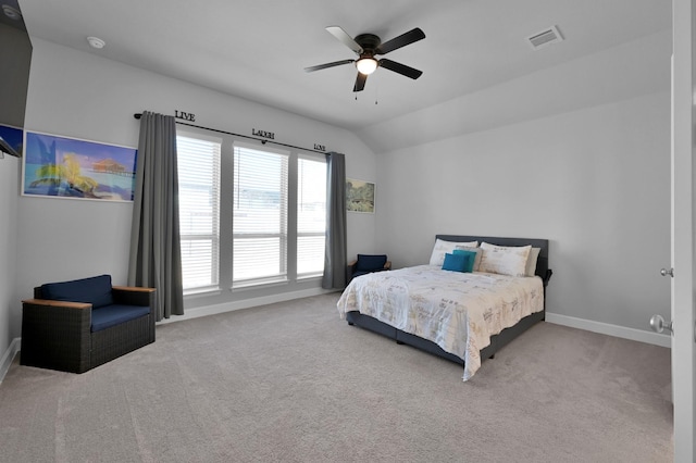 bedroom featuring visible vents, baseboards, lofted ceiling, and carpet