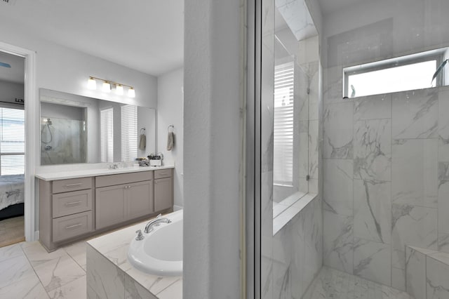 ensuite bathroom with a marble finish shower, vanity, a garden tub, marble finish floor, and ensuite bath