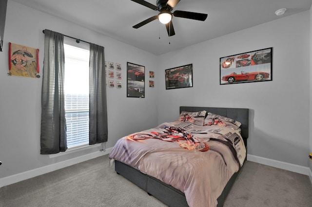 carpeted bedroom with a ceiling fan and baseboards