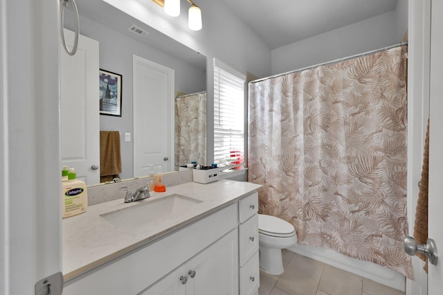 bathroom with tile patterned flooring, toilet, vanity, and visible vents