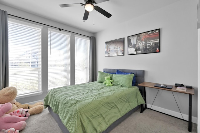 carpeted bedroom featuring baseboards and ceiling fan