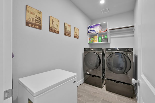 laundry area featuring laundry area, independent washer and dryer, and visible vents