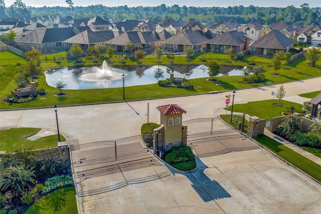 drone / aerial view featuring a residential view and a water view