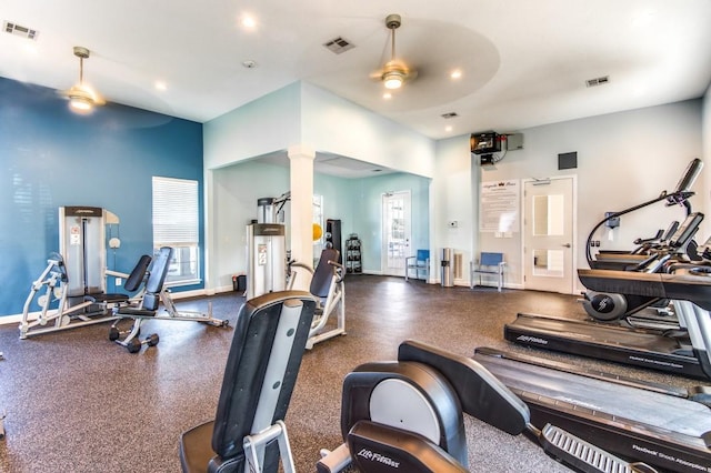 gym with visible vents, baseboards, ceiling fan, and decorative columns