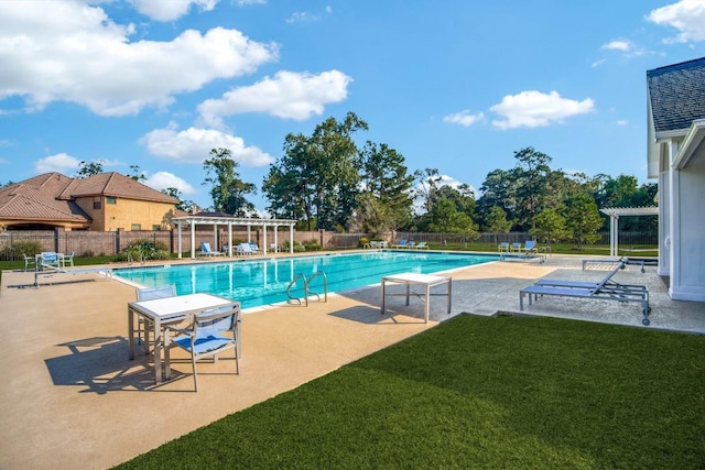 community pool featuring a patio area, fence, a pergola, and a lawn