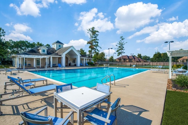 pool featuring a patio area, fence, and a pergola