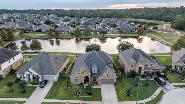 drone / aerial view featuring a residential view and a water view