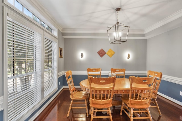 dining space with a chandelier, wood finished floors, and crown molding