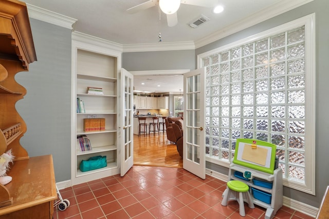 playroom with a ceiling fan, visible vents, ornamental molding, tile patterned flooring, and french doors