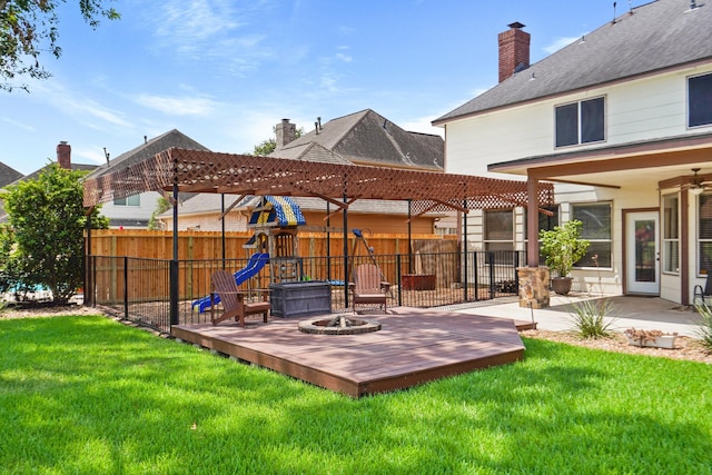 view of yard featuring a patio, fence, an outdoor fire pit, a pergola, and a playground