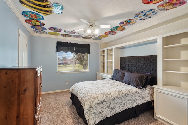 carpeted bedroom with ceiling fan, baseboards, and ornamental molding