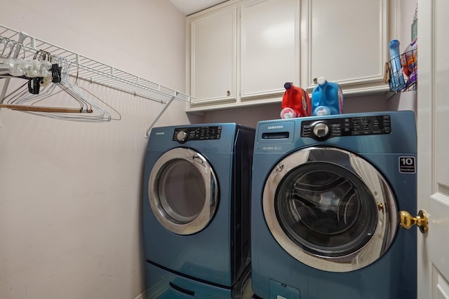 laundry room with cabinet space and washing machine and dryer