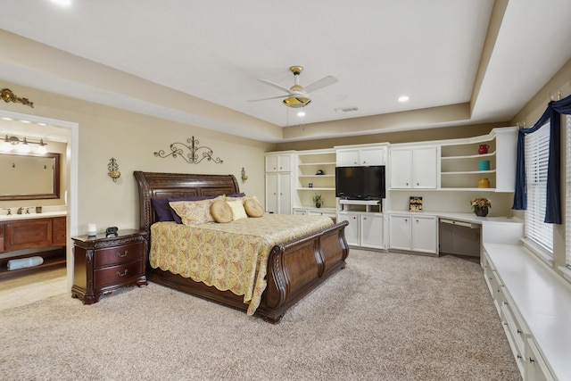 bedroom with a raised ceiling, recessed lighting, and light colored carpet