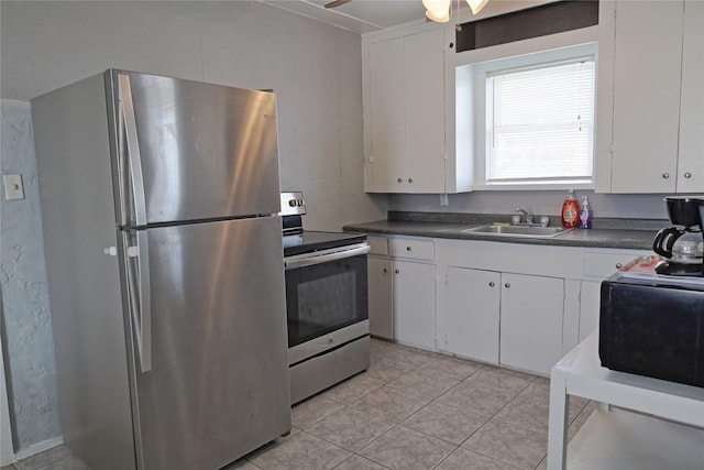 419 Murex St, Surfside Beach, TX 77541 - kitchen with white cabinetry, dark countertops, appliances with stainless steel finishes, and a sink