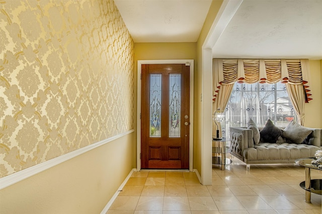 tiled entrance foyer with baseboards