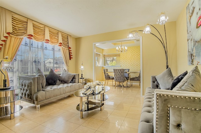 living area featuring tile patterned floors, wallpapered walls, an accent wall, and an inviting chandelier