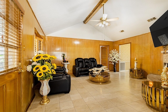 living room featuring beam ceiling, wooden walls, a ceiling fan, and visible vents