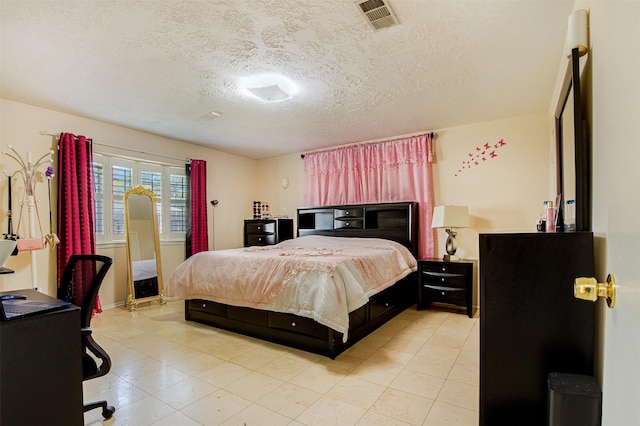 bedroom with visible vents and a textured ceiling