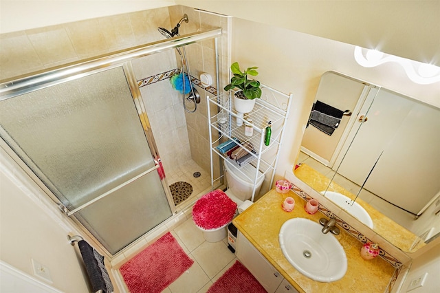 bathroom with tile patterned floors, vanity, and a shower stall