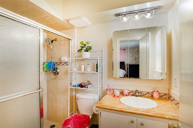 bathroom with vanity, toilet, and a stall shower